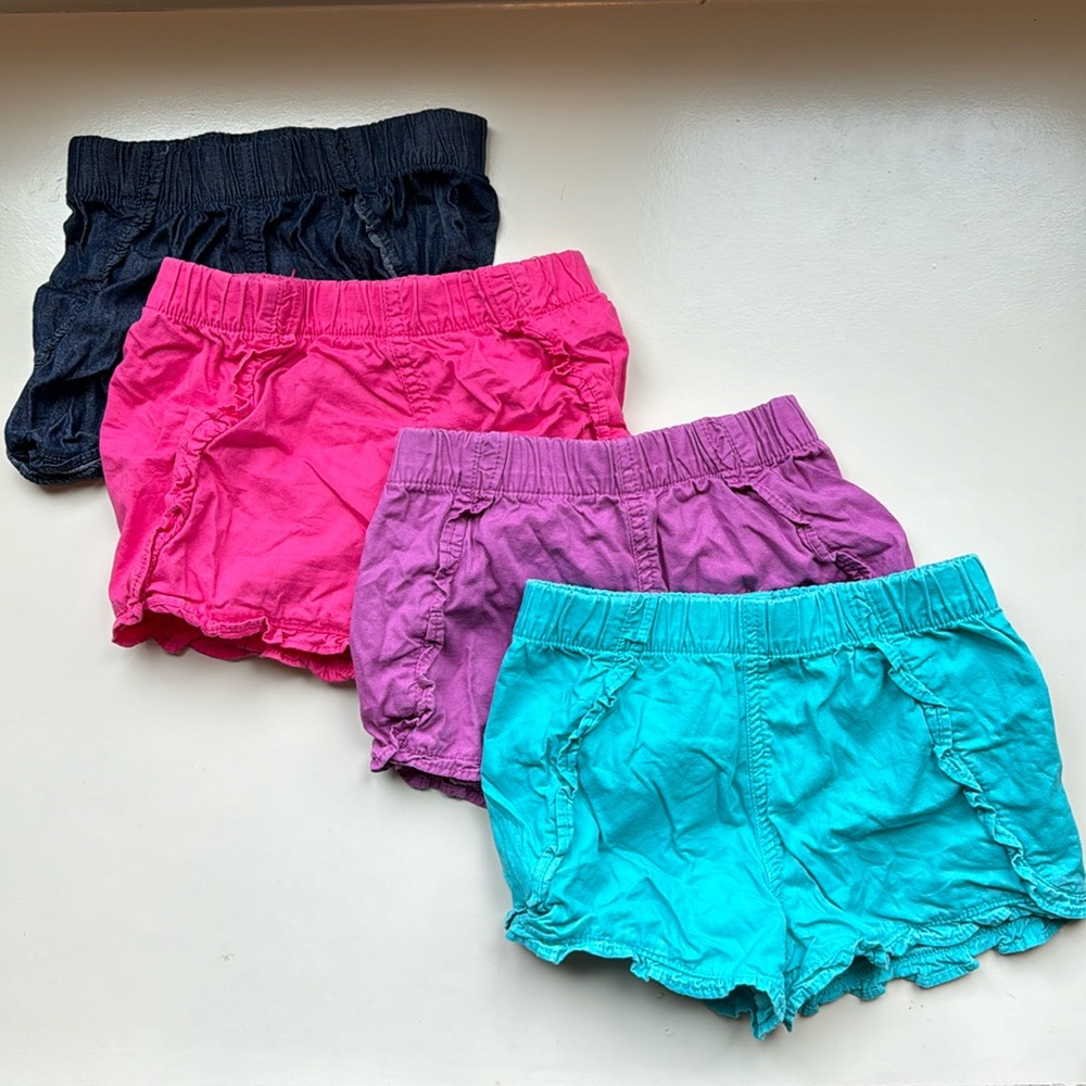 4 x Ruffle shorts in navy, pink, purple, teal. 4T